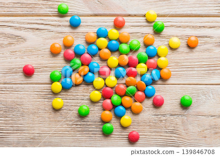 Mixed collection of colorful candy, on colored background. Flat lay, top view. frame of colorful chocolate coated candy Mixed collection of colorful candy, on colored background. Flat lay, top view. frame of colorful chocolate coated candy 139846708