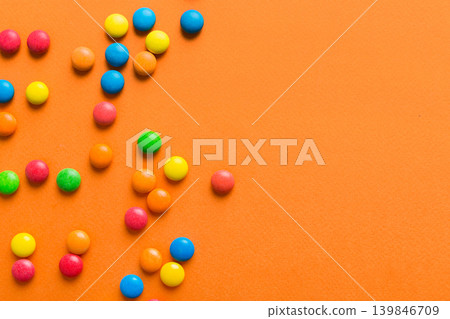 Mixed collection of colorful candy, on colored background. Flat lay, top view. frame of colorful chocolate coated candy Mixed collection of colorful candy, on colored background. Flat lay, top view. frame of colorful chocolate coated candy 139846709