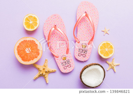 Top view composition of flip flops placed with beach accessories top view on table background. Tropical summer vacation concept Flat lay Top view composition of flip flops placed with beach accessories top view on table background. Tropical summer vacation concept Flat lay 139846821
