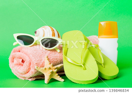 Top view composition of flip flops placed with beach accessories perspective view on table background. Tropical summer vacation concept Flat lay 139846834