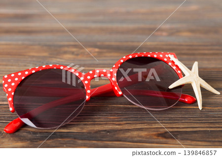 sunglasses with seashell lying on table background. Sunglasses on summer background. Top view flat lay with copy space for text sunglasses with seashell lying on table background. Sunglasses on summer background. Top view flat lay with copy space for text 139846857