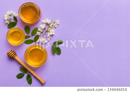 honey jar with acacia flowers and leaves. fresh honey top view flat lay honey jar with acacia flowers and leaves. fresh honey top view flat lay 139846858
