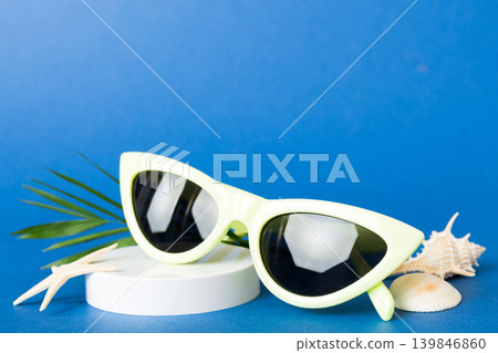sunglasses with seashell lying on table background. Sunglasses on summer background. Top view flat lay with copy space for text sunglasses with seashell lying on table background. Sunglasses on summer background. Top view flat lay with copy space for text 139846860