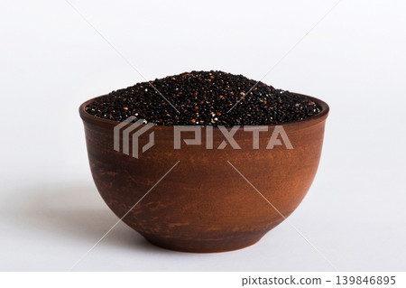 quinoa seeds in bowl on colored background. Healthy kinwa in small bowl. Healthy superfood quinoa seeds in bowl on colored background. Healthy kinwa in small bowl. Healthy superfood 139846895