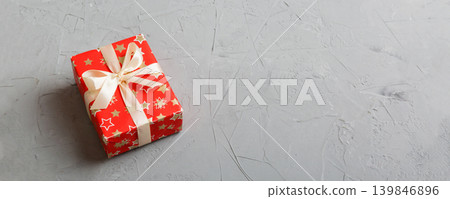 Wrapped christmas or other holiday handmade present in paper with colored ribbon. Present box, decoration of gift on table, top view with copy space Wrapped christmas or other holiday handmade present in paper with colored ribbon. Present box, decoration of gift on table, top view with copy space 139846896