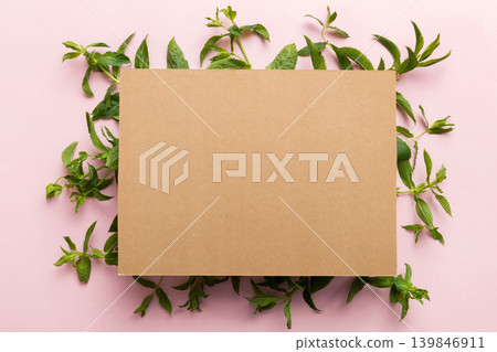 Wreath frame made of empty paper blank with space for text and mint leaves on colored background. . Mint Pattern. Flat lay. Top view 139846911