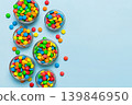 different colored round candy in bowl and jars. Top view of large variety sweets and candies with copy space 139846950