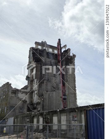 Industrial Building Facade Against a Cloudy Sky 139847022