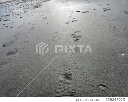Human footprints on beach sand Human footprints on beach sand 139847025