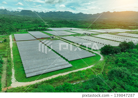 Aerial view of solar farm. Sustainable renewable energy and modern photovoltaic technology for eco-friendly electricity production. Solar power station. Green energy solutions. Solar panel technology. Aerial view of solar farm. Sustainable renewable energy and modern photovoltaic technology for eco-friendly electricity production. Solar power station. Green energy solutions. Solar panel technology. 139847287