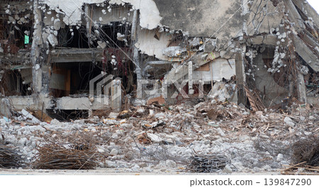 Demolished building with construction debris and scrap metal showcasing professional demolition contractor work for urban development and reconstruction projects in commercial real estate industry. 139847290