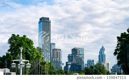 City skyline with modern skyscrapers glass building and greenery. Sustainable urban development. Urban landscape. Balance between city infrastructure, environmental planning, and clean city living. 139847313