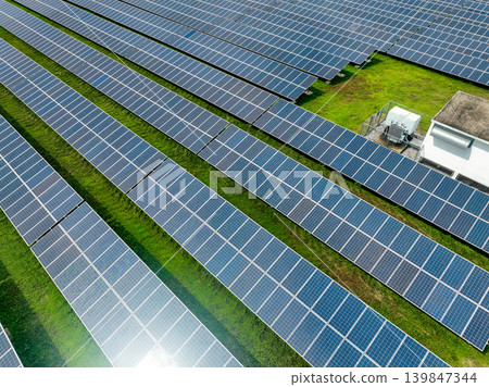 Aerial view of solar farm. Sustainable renewable energy and modern photovoltaic technology for eco-friendly electricity production. Solar power station. Green energy solutions. Solar panel technology. Aerial view of solar farm. Sustainable renewable energy and modern photovoltaic technology for eco-friendly electricity production. Solar power station. Green energy solutions. Solar panel technology. 139847344