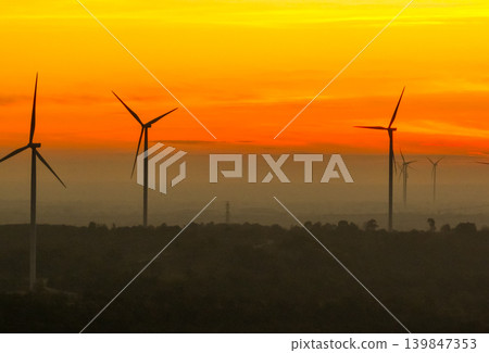 Wind farm field and sunset sky. Wind power. Sustainable, renewable energy. Wind turbines generate electricity. Sustainable development. Green technology for energy sustainability. Eco-friendly energy. 139847353