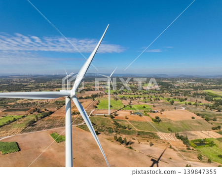 Wind energy and sustainable power generation with wind turbines, Eco-friendly solutions for renewable resources. Wind power farm and sustainable development of renewable energy, green technology. Wind energy and sustainable power generation with wind turbines, Eco-friendly solutions for renewable resources. Wind power farm and sustainable development of renewable energy, green technology. 139847355