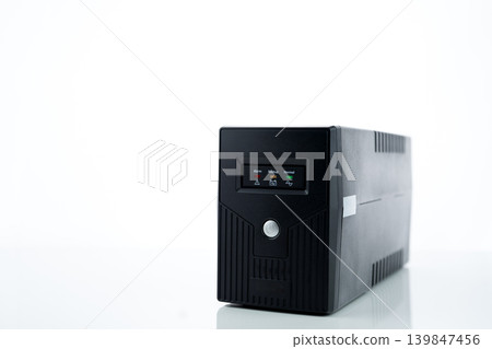 Uninterruptible power supply on white background. Backup Power UPS with battery. UPS with stabilizer for home PC. UPS inverter. Equipment for computer system at office for security. Power protection. Uninterruptible power supply on white background. Backup Power UPS with battery. UPS with stabilizer for home PC. UPS inverter. Equipment for computer system at office for security. Power protection. 139847456