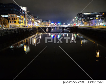 Night City Buildings Reflections In City River With Colorful Lights And Bridges, Cork City In Ireland At Night Night City Buildings Reflections In City River With Colorful Lights And Bridges, Cork City In Ireland At Night 139847568