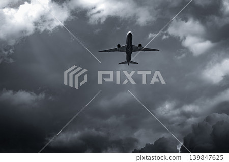 Airplane flying on dark sky and white clouds. Commercial airline with dream destinations concept. Aviation business crisis concept. Failed journey vacation flight. Air transportation. Sad travel. Airplane flying on dark sky and white clouds. Commercial airline with dream destinations concept. Aviation business crisis concept. Failed journey vacation flight. Air transportation. Sad travel. 139847625