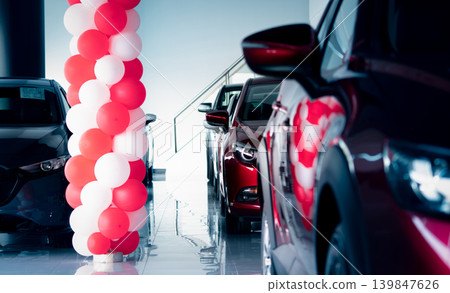New and shiny luxury SUV car parked in modern showroom with sale promotion events. Car dealership office. Electric car business. Automobile leasing. Automotive industry. Showroom decor with balloons. New and shiny luxury SUV car parked in modern showroom with sale promotion events. Car dealership office. Electric car business. Automobile leasing. Automotive industry. Showroom decor with balloons. 139847626