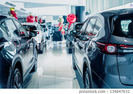 Selective focus grey car parked in luxury showroom. Car dealership office. New car parked in modern showroom. Car for sale and rent business concept. Automobile leasing and insurance background. Selective focus grey car parked in luxury showroom. Car dealership office. New car parked in modern showroom. Car for sale and rent business concept. Automobile leasing and insurance background. 139847632