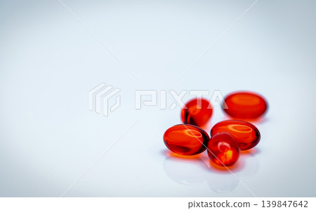 Red soft gel capsule pills isolated on white background. Pile of red soft gelatin capsule. Vitamins and dietary supplements concept. Pharmaceutical industry. Pharmacy drug store. Health care products. Red soft gel capsule pills isolated on white background. Pile of red soft gelatin capsule. Vitamins and dietary supplements concept. Pharmaceutical industry. Pharmacy drug store. Health care products. 139847642