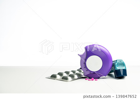Asthma inhaler, accuhaler and anti allergy pills on white table for respiratory disease treatment, bronchodilator and steroid medication used as asthma controller and reliever in healthcare concept. Asthma inhaler, accuhaler and anti allergy pills on white table for respiratory disease treatment, bronchodilator and steroid medication used as asthma controller and reliever in healthcare concept. 139847652