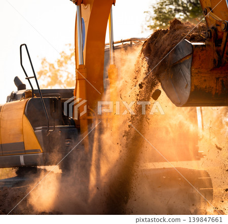 Close-up of excavator at construction site. Backhoe digging soil for earthwork and construction business. Excavating machine at work. Heavy machinery for earth moving and construction site development Close-up of excavator at construction site. Backhoe digging soil for earthwork and construction business. Excavating machine at work. Heavy machinery for earth moving and construction site development 139847661