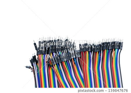 Ribbon cable or multi-wire planar cable on white background. Flat ribbon cable with pin connectors. Multi-colored ribbon computer connecting cable. Connecting pins. Electronic component of computer. 139847676