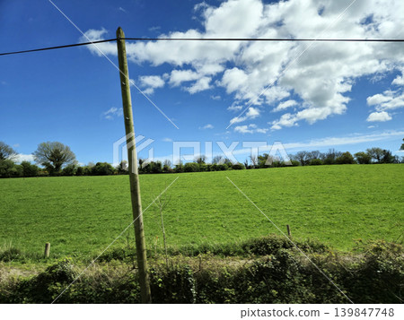 Beautiful Green Valley And Fields Of Ireland Under Deep Blue Summer Sky Natural Background Beautiful Green Valley And Fields Of Ireland Under Deep Blue Summer Sky Natural Background 139847748