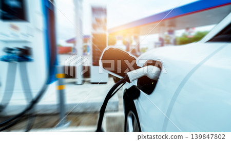 EV car charging at outdoor electric car charging station. EV car charging point. Electric vehicle fast charge concept. DC fast charging station. Quick charge concept. Sustainable power. Green energy. 139847802