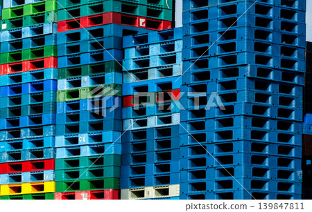 Pile of plastic shipping pallet. Industrial plastic pallet stacked at factory warehouse. Cargo and shipping concept. Plastic pallet rack for export delivery industry. Plastic pallet storage warehouse. Pile of plastic shipping pallet. Industrial plastic pallet stacked at factory warehouse. Cargo and shipping concept. Plastic pallet rack for export delivery industry. Plastic pallet storage warehouse. 139847811