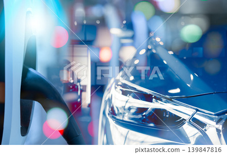 Electric vehicle charging station and EV car in a showroom. Electric vehicle dealership. Clean and sustainable energy. Commercial EV charging point. Charging infrastructure. Electric car technology. 139847816