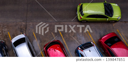 Top view of car parked at concrete car parking lot with yellow line of traffic sign on the street. Above view of car in a row at parking space. No available parking slot. Outside car parking area. Top view of car parked at concrete car parking lot with yellow line of traffic sign on the street. Above view of car in a row at parking space. No available parking slot. Outside car parking area. 139847851