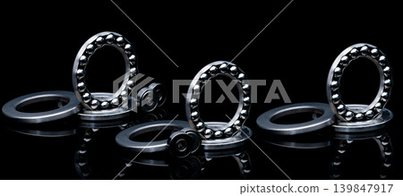 Stainless steel thrust ball bearing. Set of thrust ball bearing and shiny silver ball bearing. Spare parts for roller machine in heavy machinery and automotive industry. Round metal wheel. 139847917