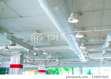 Air duct, air conditioner pipe, fire sprinkler system. Air flow and ventilation system. Building interior. Ceiling lamp light with opened light. Interior architecture. Glass wall building. Air duct, air conditioner pipe, fire sprinkler system. Air flow and ventilation system. Building interior. Ceiling lamp light with opened light. Interior architecture. Glass wall building. 139847920