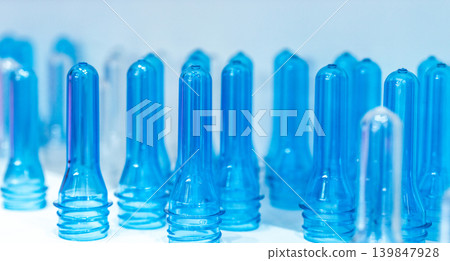PET plastic bottle preforms before blow molding. Packaging industry. PET preforms from preforms injection molding machine. Raw material for PET bottle. Recycle plastic. Polyethylene terephthalate. 139847928