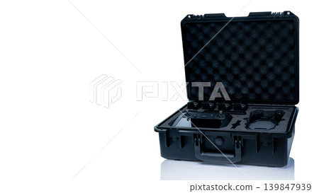 Drone kit in hard protective case, aerial device with accessories and LiPo battery for photography, videography and inspection tasks, modern technology equipment for safe transport and organization. Drone kit in hard protective case, aerial device with accessories and LiPo battery for photography, videography and inspection tasks, modern technology equipment for safe transport and organization. 139847939