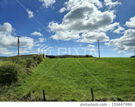 Beautiful Green Valley And Fields Of Ireland Under Deep Blue Summer Sky Natural Background Beautiful Green Valley And Fields Of Ireland Under Deep Blue Summer Sky Natural Background 139847999