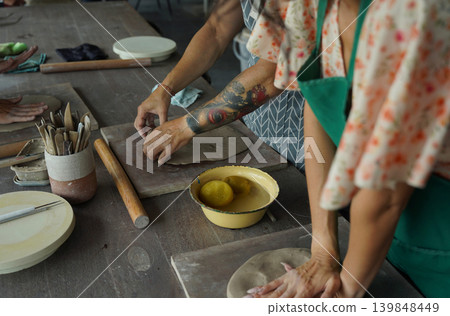 A happy couple makes ceramic plates in a workshop A happy couple makes ceramic plates in a workshop 139848449