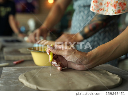 A happy couple makes ceramic plates in a workshop A happy couple makes ceramic plates in a workshop 139848451