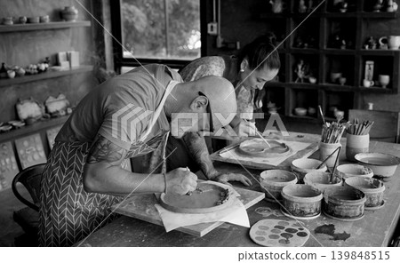 A happy couple makes ceramic plates in a workshop A happy couple makes ceramic plates in a workshop 139848515