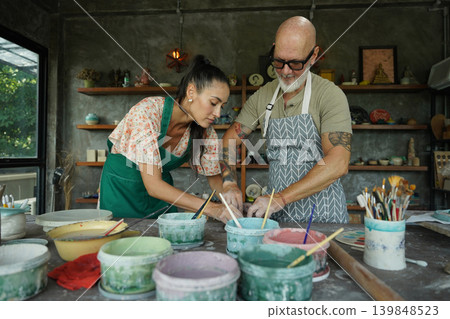 A happy couple makes ceramic plates in a workshop A happy couple makes ceramic plates in a workshop 139848523