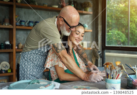 A happy couple makes ceramic plates in a workshop A happy couple makes ceramic plates in a workshop 139848525