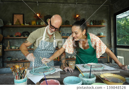 A happy couple makes ceramic plates in a workshop A happy couple makes ceramic plates in a workshop 139848526