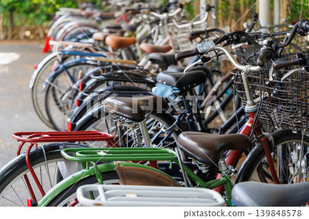Bicycles parked neatly in a row in the bicycle parking area. 139848578