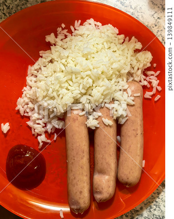 Boiled rice with sausages and ketchup meal 139849111