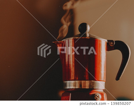The essence of a cozy morning with this vibrant, steaming red moka pot. Home coffee brewing, authentic Italian espresso culture, lifestyle aesthetic. The essence of a cozy morning with this vibrant, steaming red moka pot. Home coffee brewing, authentic Italian espresso culture, lifestyle aesthetic. 139850207