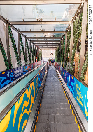 Phu Quoc, Vietnam - January 3 2026: Covered Outdoor Escalator Descending to Festive Plaza Phu Quoc, Vietnam - January 3 2026: Covered Outdoor Escalator Descending to Festive Plaza 139850255