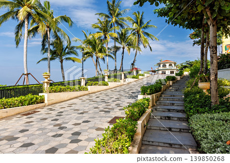 Phu Quoc, Vietnam - January 3 2026: Palm-lined tropical promenade near seaside restaurant in Phu Quoc Phu Quoc, Vietnam - January 3 2026: Palm-lined tropical promenade near seaside restaurant in Phu Quoc 139850268