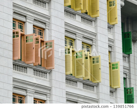 Historic building facade showcasing colorful shutters and intricate architectural elements Historic building facade showcasing colorful shutters and intricate architectural elements 139851766